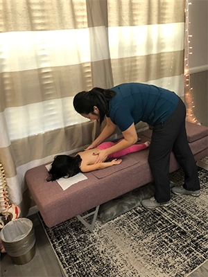 Chiropractor Las Vegas NV Justine Rhee With Young Patient